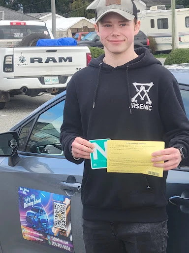 Happy student holding his N sign after passing his road test